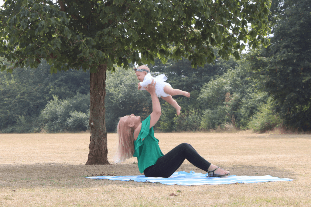 modernised mom playing with baby throwing baby in air